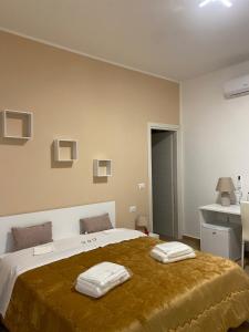 a bedroom with a large bed with two towels on it at G&G Home in Cosenza