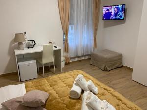 a bedroom with a bed with towels on it at G&G Home in Cosenza