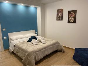 a bedroom with a bed with two towels on it at G&G Home in Cosenza
