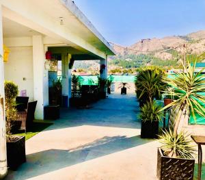 a building with a patio with plants and a pool at Republika by Summit Resorts in Abbottabad