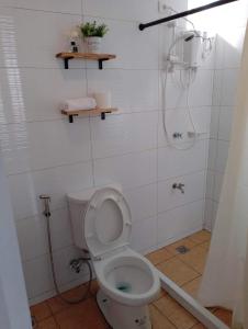 a bathroom with a toilet and a shower at The White Pine at No 7 Pucay Village in Baguio