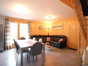 a living room with a table and a couch at Beau chalet 4 chambres, terrasse, garage, WiFi au Mont-Dore - FR-1-608-223 in Le Mont-Dore