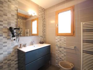 a bathroom with a sink and a mirror and a shower at Beau chalet 4 chambres, terrasse, garage, WiFi au Mont-Dore - FR-1-608-223 in Le Mont-Dore +11 photos