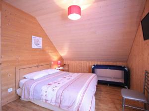 a bedroom with a bed and a tv in a attic at Chalet Mont-Dore, 5 pièces, 8 personnes - FR-1-608-223 in Le Mont-Dore
