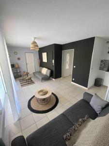 a living room with a couch and a table at Appartement Centre Ville Sainte-Maxime Tout à Pied in Sainte-Maxime