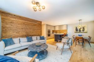a living room with a couch and a table at Saas-Fee stylish ski apartment in Saas-Fee