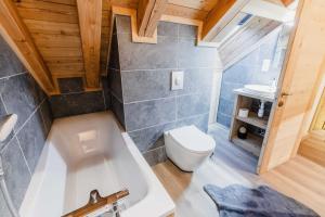 une salle de bain avec toilettes et baignoire dans l'établissement Les Loups Blancs, duplex rénové en 2022, pied des pistes, à Montgenèvre 21 autres photos