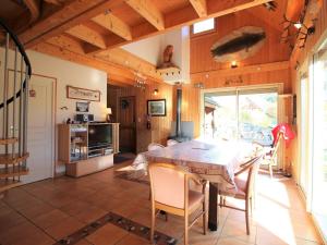 a kitchen and dining room with a table and chairs at Mont-Dore : Chalet spacieux avec parking et grand terrain - FR-1-608-106 in Le Mont-Dore
