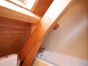 a bathroom with a white tub and a wooden ceiling at Mont-Dore : Chalet spacieux avec parking et grand terrain - FR-1-608-106 in Le Mont-Dore