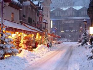 a street covered in snow in a city at Appartement Mont-Dore, 2 pièces, 4 personnes - FR-1-608-108 in Le Mont-Dore