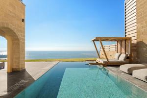 a villa with a swimming pool and a patio at Mani Theasis in Stoupa