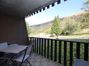 a balcony with a table and chairs and a view at Appartement Mont-Dore, 2 pièces, 4 personnes - FR-1-608-142 in Le Mont-Dore