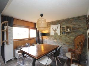 a dining room with a wooden table and chairs at Appartement Mont-Dore, 2 pièces, 4 personnes - FR-1-608-142 in Le Mont-Dore
