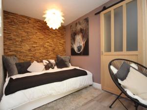 a bedroom with a bed and two chairs at Appartement Mont-Dore, 2 pièces, 4 personnes - FR-1-608-142 in Le Mont-Dore