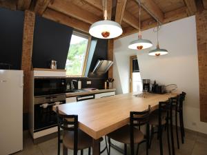 eine Küche mit einem großen Holztisch und Stühlen in der Unterkunft Charmant Duplex T3 au Mont-Dore, à 300m des Thermes, avec Parking et WiFi ! - FR-1-608-151 in Le Mont-Dore