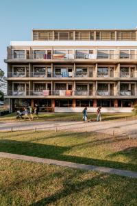 a building with people walking in front of it at Vintage Hotel Parque do Rio in Esposende