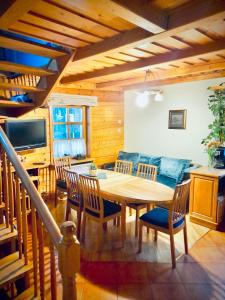 a dining room with a wooden table and chairs at Vila Kopa Nida in Nida