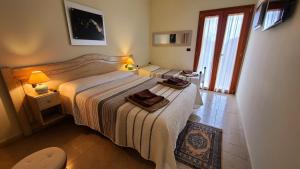 a bedroom with two beds with towels on it at Villa Anna Salento in Presicce +36 photos
