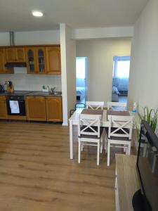 a kitchen and dining room with a table and chairs at Apartment Gloria in Peroj