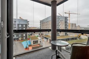a view from a balcony with a table and chairs at Hiisi Homes Turku Ratapiha in Turku
