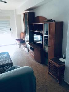 a living room with a couch and a cabinet at Beach apartment-VillaJoyosa, north Alicante in Villajoyosa