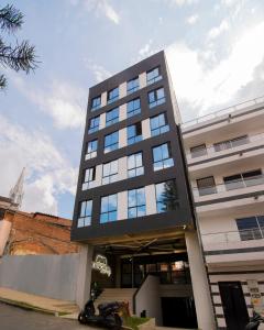 a tall black building with a motorcycle parked in front of it at MANGATA LIVING in Medellín