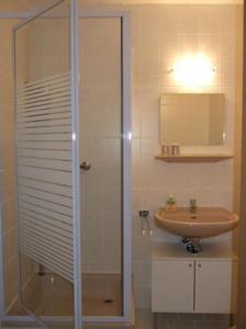 a bathroom with a glass shower and a sink at Pension Rotsteinblick in Sohland am Rotstein