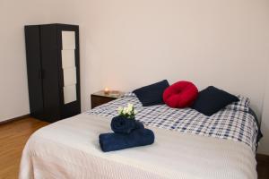 a bedroom with a bed with blue and red pillows at Mikasa Balduina Roma in Rome