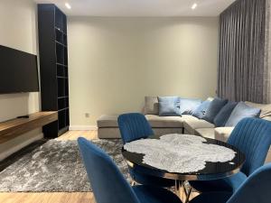 a living room with a couch and a table and chairs at Ташкент сити in Tashkent