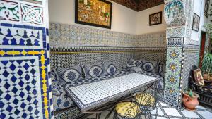 a room with blue and white tiles on the wall at Riad Green House in Fès