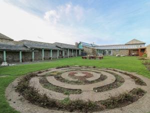 a large stone labyrinth in the middle of a yard at Lower Treginnis Farm in St. Davids