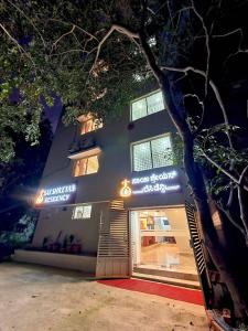 班加羅爾的住宿－Sai Shreyas Residency, Best Hotel near Bangalore Airport，夜间在建筑物前的商店