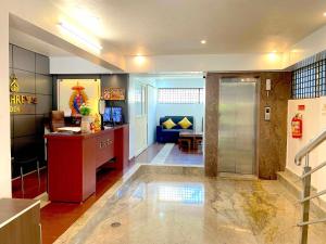 a lobby with a reception desk and a couch at Sai Shreyas Residency, Boutique Hotel near Bangalore Airport in Bangalore