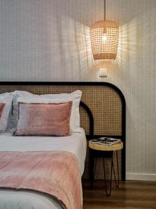 a bedroom with a bed and a table with a lamp at The Bastion Elvas Apartments in Elvas
