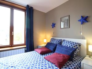 a bedroom with a bed with blue stars on the wall at Appartement T3 avec Parking à La Bourboule, à 500m des Thermes et du Centre, WiFi Inclus - FR-1-608-14 in La Bourboule