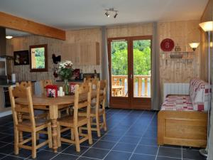 a kitchen and dining room with a wooden table and chairs at Chalet 4* avec WIFI au Mont-Dore - FR-1-608-31 in Le Mont-Dore +10 photos