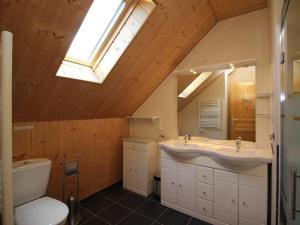 a bathroom with a sink and a toilet and a skylight at Chalet Mont-Dore, 5 pièces, 8 personnes - FR-1-608-31 in Le Mont-Dore