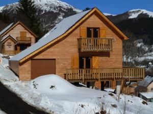 a log home with a deck in the snow at Chalet Mont-Dore, 5 pièces, 8 personnes - FR-1-608-31 in Le Mont-Dore