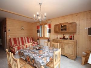 a kitchen and dining room with a table and chairs at Chalet au Mont-Dore avec terrasse, 2 ch., navette ski, prox. centre & sentiers - FR-1-608-41 in Le Mont-Dore +8 photos