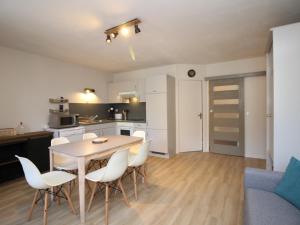 a kitchen and dining room with a table and chairs at Appartement Mont-Dore, 3 pièces, 5 personnes - FR-1-608-40 in Le Mont-Dore