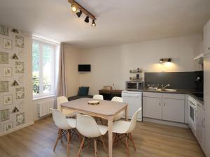 a kitchen and dining room with a table and chairs at Appartement Mont-Dore, 3 pièces, 5 personnes - FR-1-608-40 in Le Mont-Dore