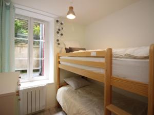 two bunk beds in a room with a window at Appartement Mont-Dore, 3 pièces, 5 personnes - FR-1-608-40 in Le Mont-Dore