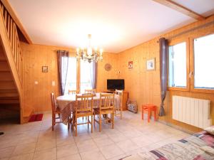 a dining room with a table and chairs at Chalet spacieux avec terrasse et poêle à bois près du centre - FR-1-608-65 in Le Mont-Dore