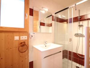 a bathroom with a sink and a shower at Chalet spacieux avec terrasse et poêle à bois près du centre - FR-1-608-65 in Le Mont-Dore +8 photos