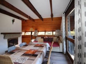 a bedroom with a bed and a fireplace at Chalet Mont-Dore, 4 pièces, 9 personnes - FR-1-608-88 in Le Mont-Dore