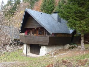 a large wooden house on top of a hill at Mont-Dore : Chalet agréable avec WIFI pour 9 personnes - FR-1-608-88 in Le Mont-Dore
