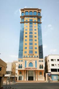 a tall building with a clock tower at Al Azhar Almassi Hotel in Mecca
