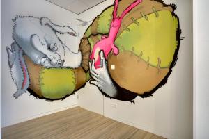 a wall mural of a baseball glove and an elephant at Dutchies Hostel in Amsterdam