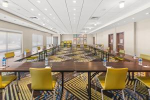 a large conference room with tables and yellow chairs at Holiday Inn Express Hotel & Suites Willows, an IHG Hotel in Willows