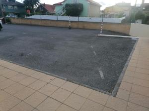 an empty parking lot in a residential neighborhood at Apartamento céntrico con piscina y garaje in Suances